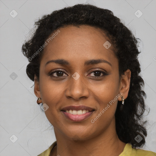 Joyful black young-adult female with long  black hair and brown eyes