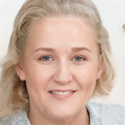 Joyful white young-adult female with medium  brown hair and blue eyes