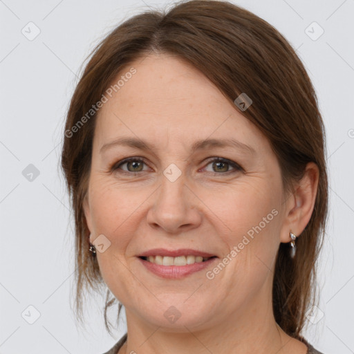 Joyful white adult female with medium  brown hair and grey eyes