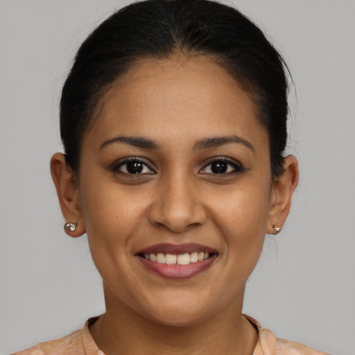 Joyful latino young-adult female with short  brown hair and brown eyes