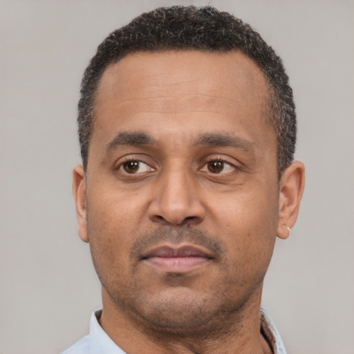 Neutral latino adult male with short  black hair and brown eyes
