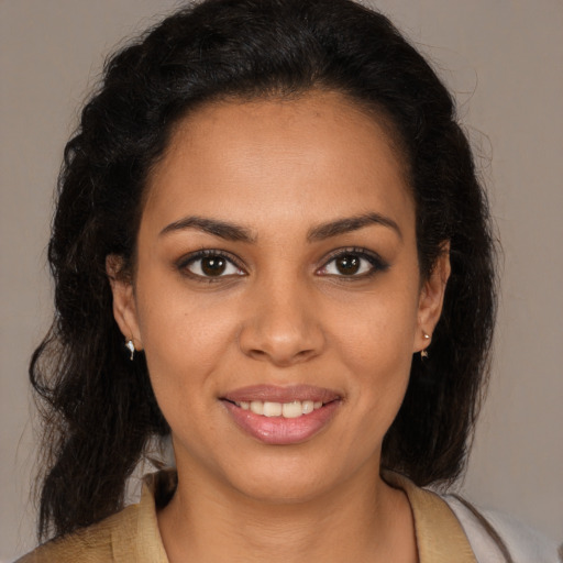 Joyful black young-adult female with medium  brown hair and brown eyes