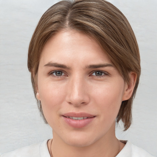 Joyful white young-adult female with medium  brown hair and grey eyes