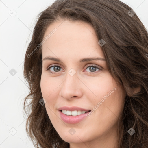 Joyful white young-adult female with long  brown hair and green eyes