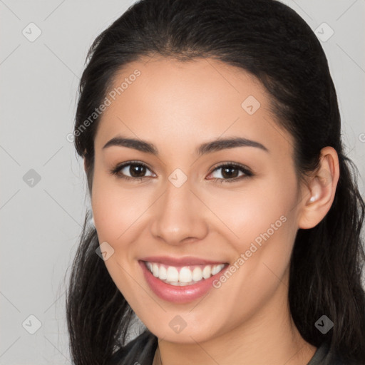 Joyful latino young-adult female with long  brown hair and brown eyes