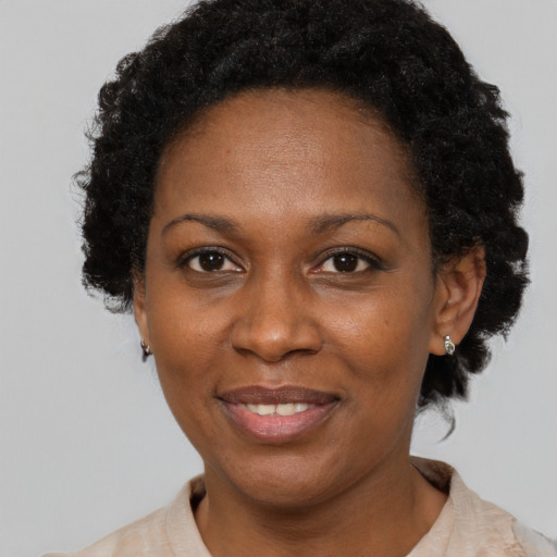 Joyful black adult female with short  brown hair and brown eyes