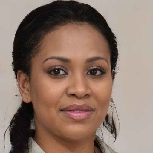Joyful black young-adult female with medium  brown hair and brown eyes