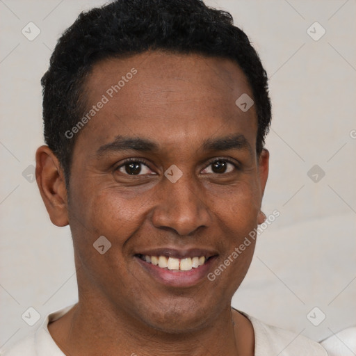 Joyful black young-adult male with short  black hair and brown eyes