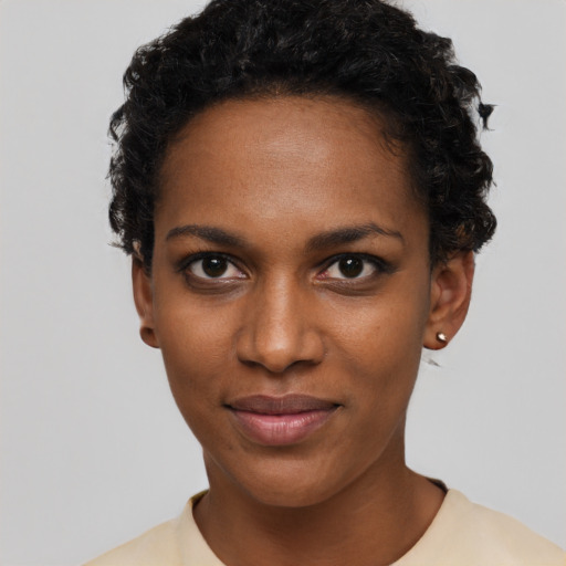 Joyful black young-adult female with short  black hair and brown eyes