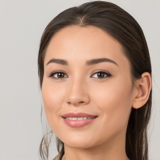 Joyful white young-adult female with long  brown hair and brown eyes