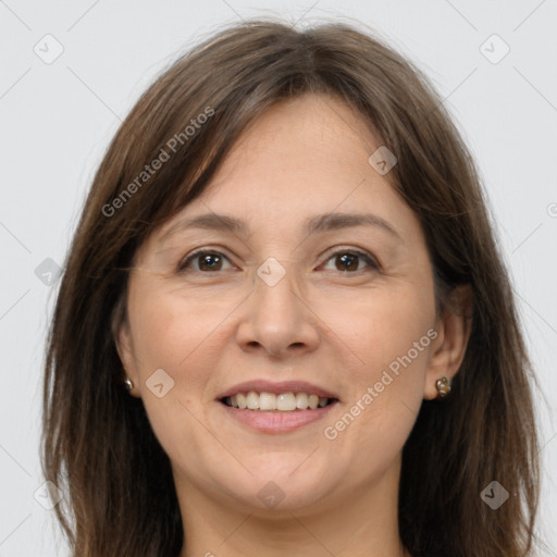 Joyful white adult female with long  brown hair and grey eyes