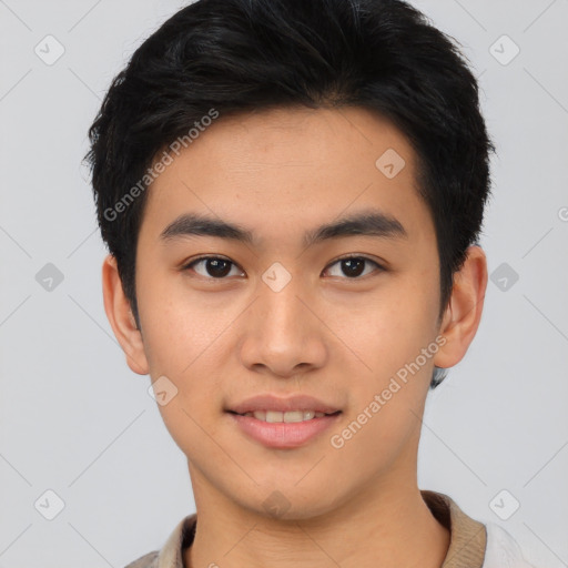 Joyful asian young-adult male with short  black hair and brown eyes