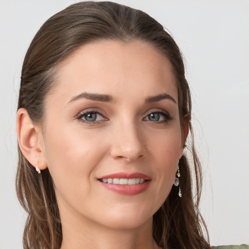 Joyful white young-adult female with long  brown hair and grey eyes