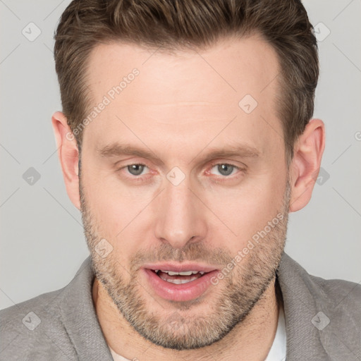 Joyful white adult male with short  brown hair and brown eyes