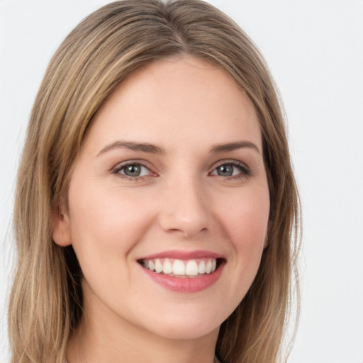 Joyful white young-adult female with long  brown hair and green eyes