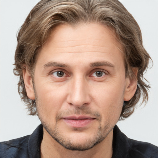 Joyful white adult male with short  brown hair and grey eyes