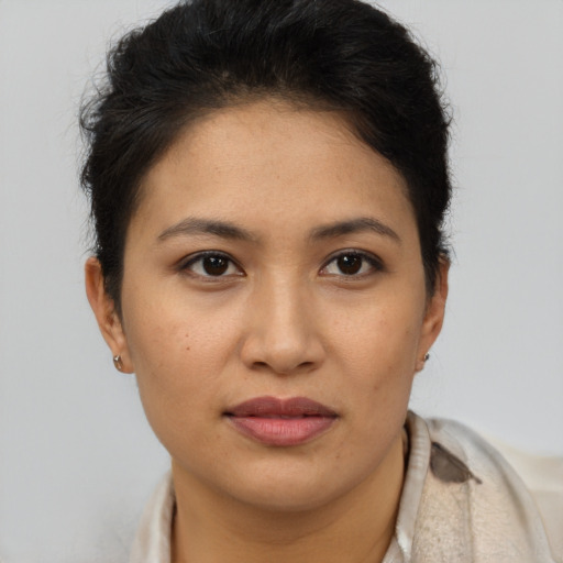 Joyful latino young-adult female with short  brown hair and brown eyes