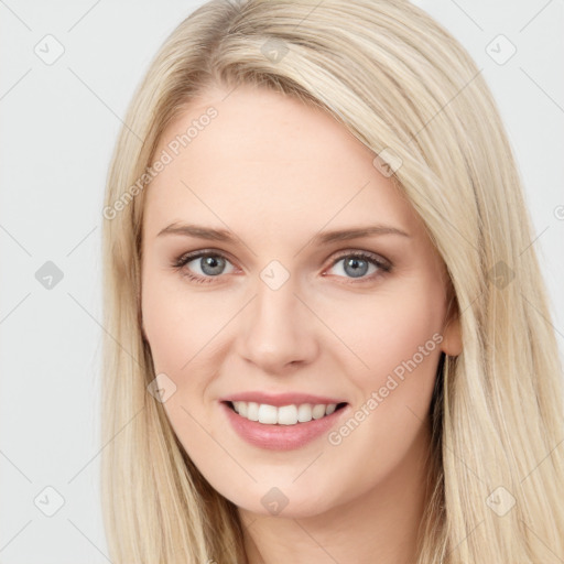 Joyful white young-adult female with long  brown hair and blue eyes