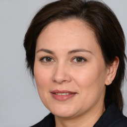 Joyful white adult female with medium  brown hair and brown eyes