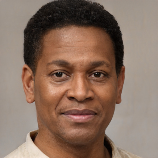 Joyful latino adult male with short  brown hair and brown eyes