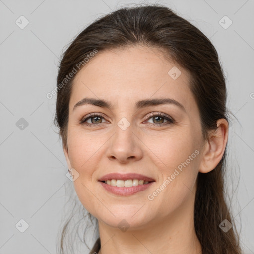 Joyful white young-adult female with long  brown hair and brown eyes