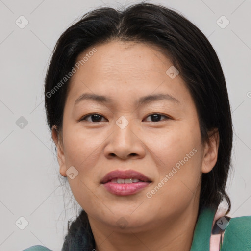 Joyful asian adult female with medium  brown hair and brown eyes