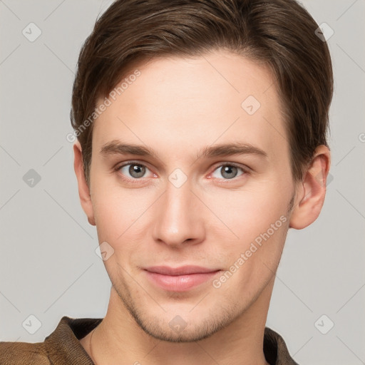 Joyful white young-adult male with short  brown hair and grey eyes