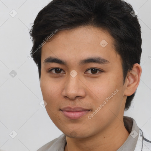 Joyful asian young-adult male with short  brown hair and brown eyes