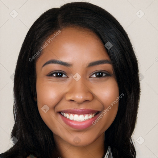 Joyful black young-adult female with long  black hair and brown eyes