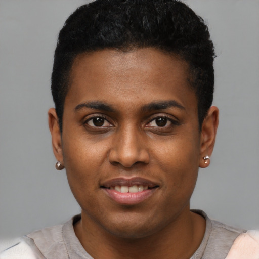 Joyful black young-adult male with short  brown hair and brown eyes