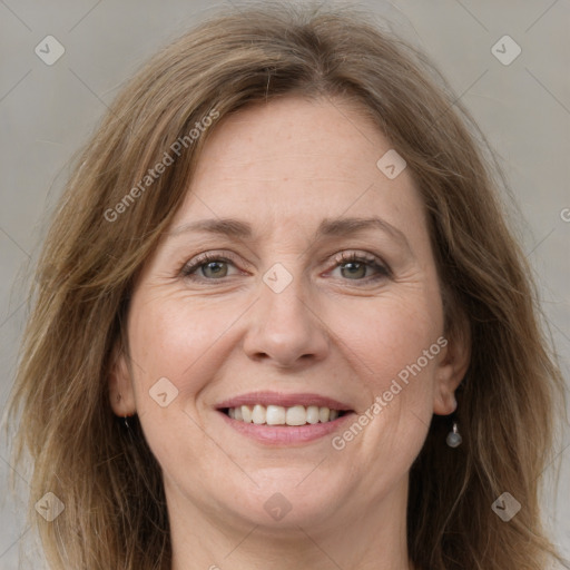 Joyful white adult female with long  brown hair and grey eyes