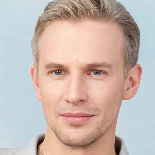 Joyful white adult male with short  brown hair and grey eyes