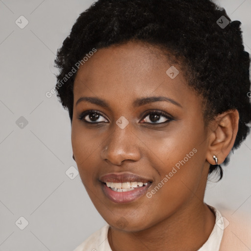 Joyful black young-adult female with short  black hair and brown eyes