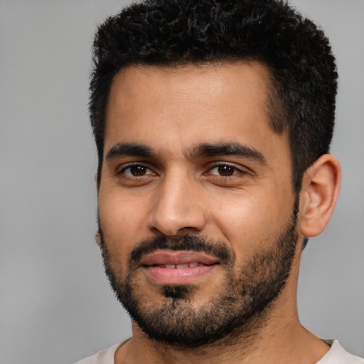 Joyful latino young-adult male with short  black hair and brown eyes