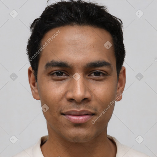 Joyful latino young-adult male with short  black hair and brown eyes