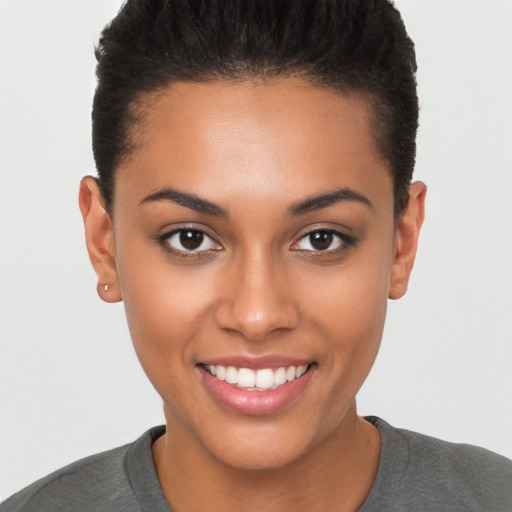 Joyful latino young-adult female with short  brown hair and brown eyes