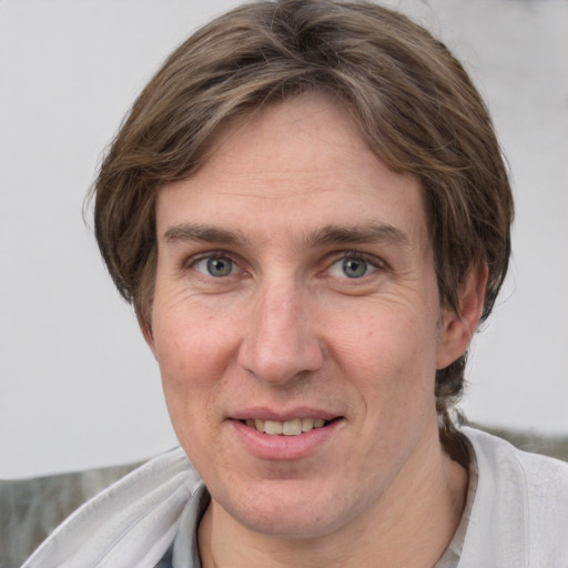 Joyful white adult female with short  brown hair and grey eyes