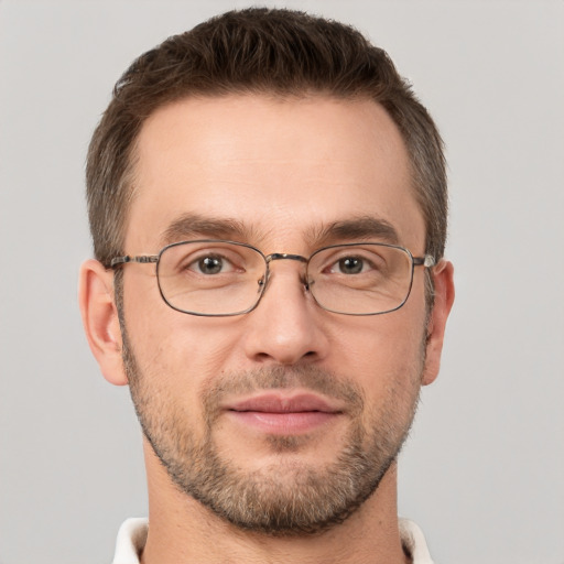 Joyful white adult male with short  brown hair and brown eyes