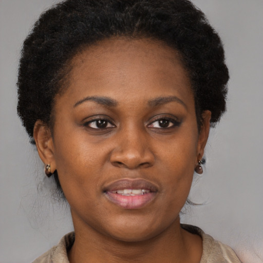 Joyful black young-adult female with medium  brown hair and brown eyes