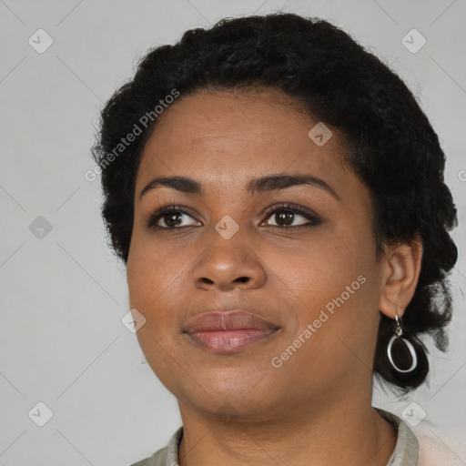 Joyful black young-adult female with short  black hair and brown eyes