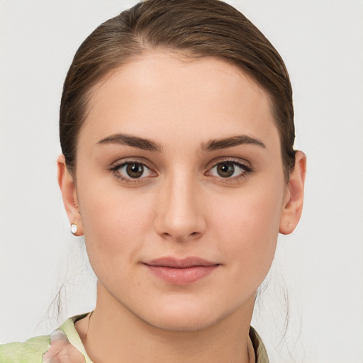 Joyful white young-adult female with medium  brown hair and grey eyes