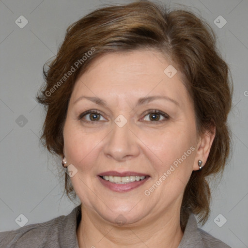 Joyful white adult female with medium  brown hair and brown eyes