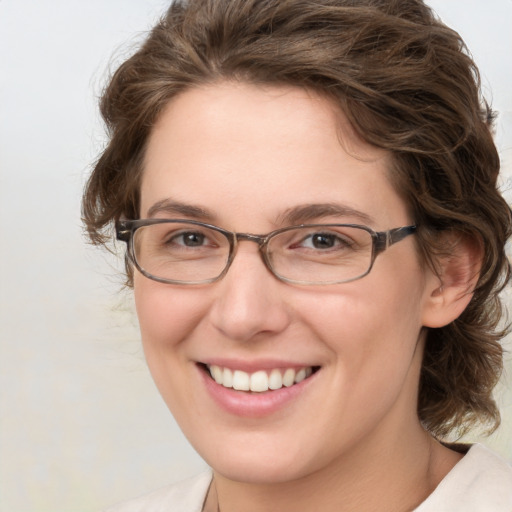 Joyful white young-adult female with medium  brown hair and green eyes