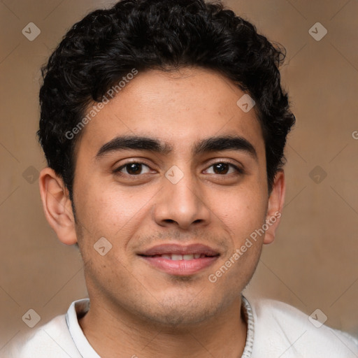 Joyful latino young-adult male with short  brown hair and brown eyes