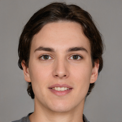 Joyful white young-adult male with medium  brown hair and brown eyes