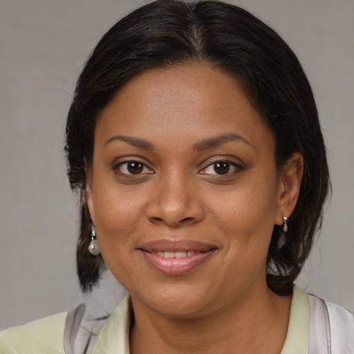 Joyful black young-adult female with medium  brown hair and brown eyes