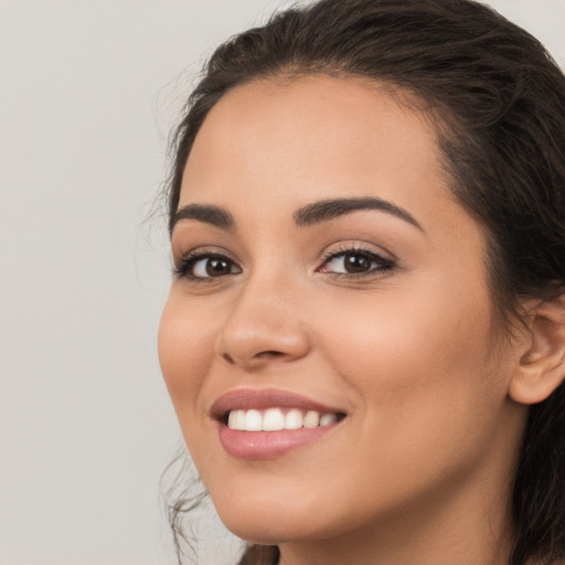 Joyful white young-adult female with long  brown hair and brown eyes