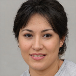 Joyful white adult female with medium  brown hair and brown eyes