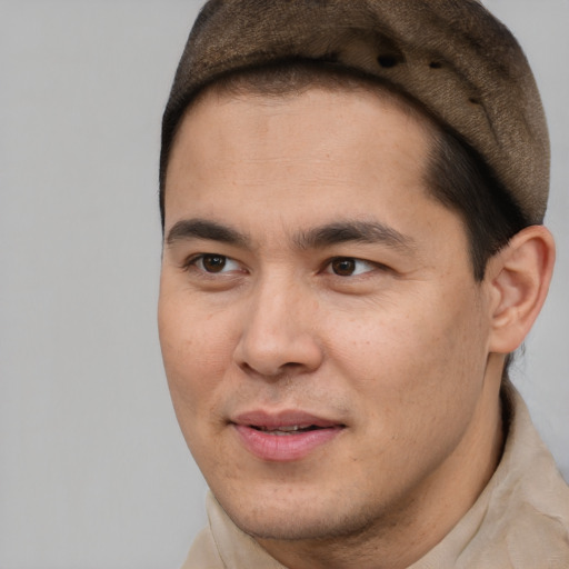 Joyful latino young-adult male with short  brown hair and brown eyes