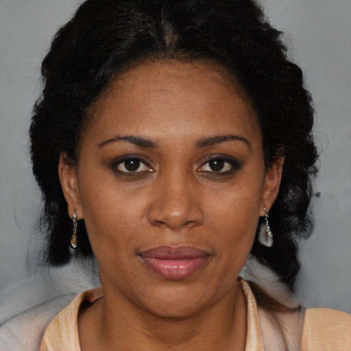 Joyful black adult female with medium  brown hair and brown eyes